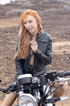 Lilly Mays Rides A Motorcycle In The Desert Wearing A Leather Jacket And Miniskirt
